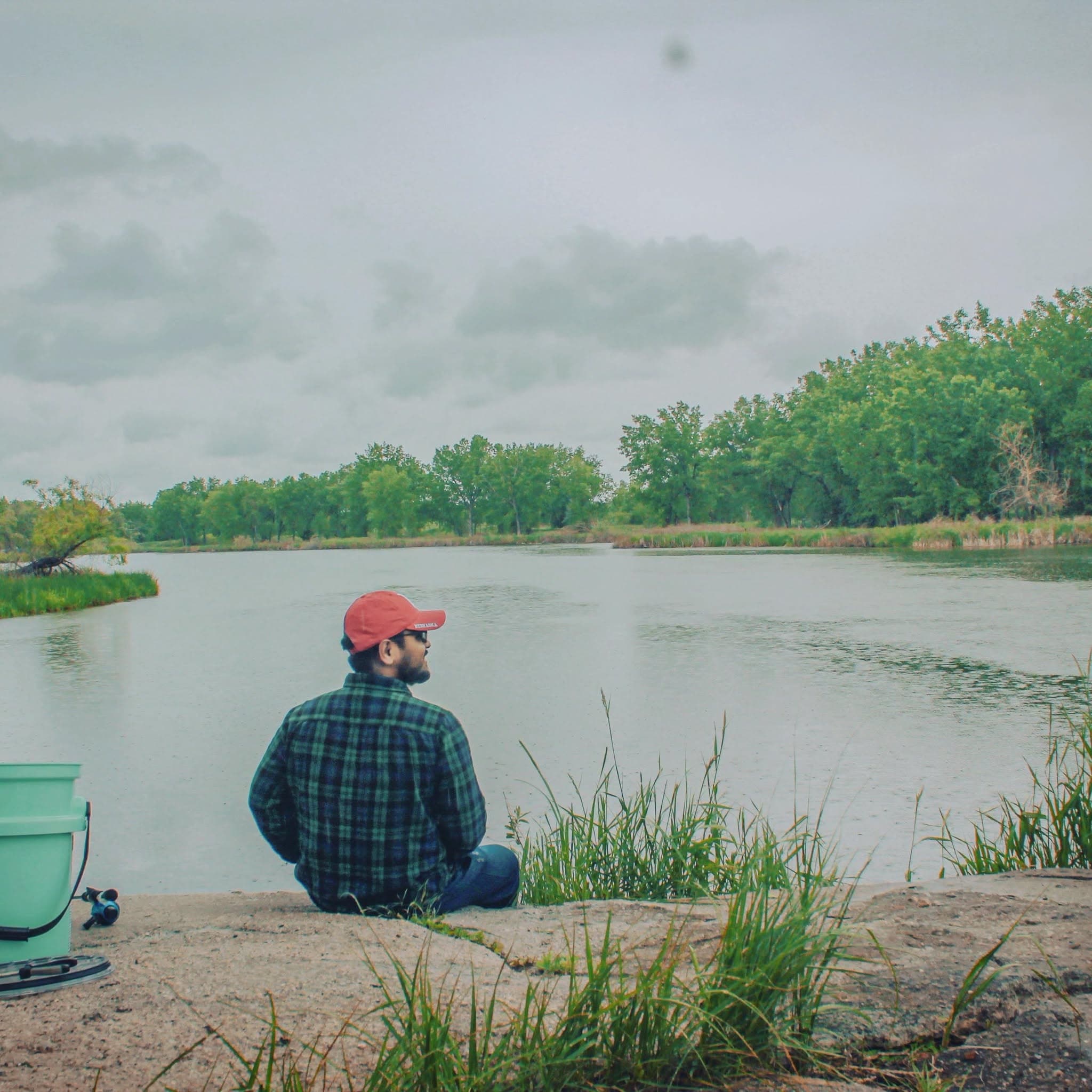 Dr. Saurav Das seated beside a lake